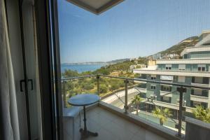 a balcony with a view of the ocean at Britannia Resort & SPA in Vlorë
