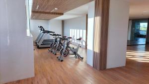 a gym with two exercise bikes in a room at Mactan Airport 1BR Resort with Pool in Mactan Island