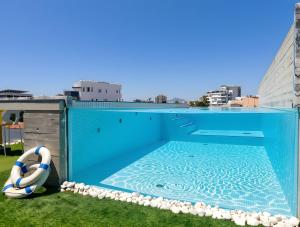 a swimming pool on the roof of a building at Lokàl Boutique Hotel in Larnaca
