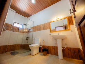 a bathroom with a toilet and a sink and a mirror at Lava Ella in Ella +46 photos