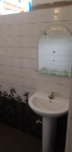 a bathroom with a white sink and a mirror at 53 Villa in Habaraduwa Central