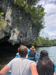 a group of people on a boat in a cave at Mangrove Reef Guest House in Airborei