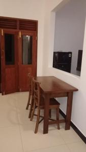 a wooden table and chairs in a room at 53 Villa in Habaraduwa Central +11 photos