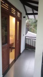 a door leading into a room with a balcony at 53 Villa in Habaraduwa Central