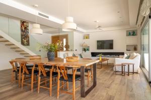 a dining room and living room with a table and chairs at Modern Villa Olivera with Private Pool in Calella de Palafrugell