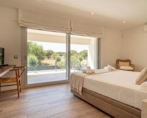 a bedroom with a bed and a large window at Modern Villa Olivera with Private Pool in Calella de Palafrugell +36 photos