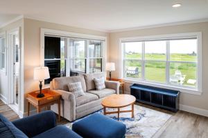 a living room with a couch and a table at Rodd Crowbush Golf & Beach Resort in Morell