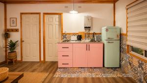 a kitchen with a pink refrigerator in a room at Tiny house in Coñaripe