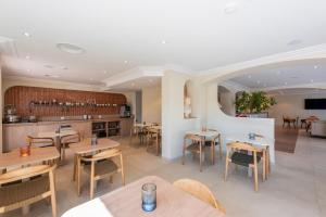 a restaurant with tables and chairs and a bar at Le Petit Prince in Sainte-Maxime