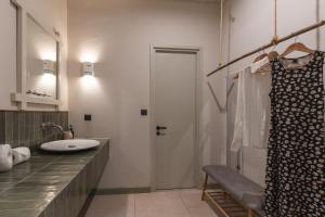 a bathroom with a sink and a shower with a mirror at Filanthi - The project in Methoni +127 photos