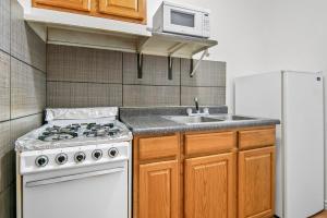 a kitchen with a white stove and a sink at Americas Best Value Inn Weatherford in Weatherford