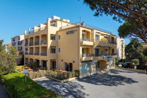a large apartment building with a parking lot at Le Petit Prince in Sainte-Maxime