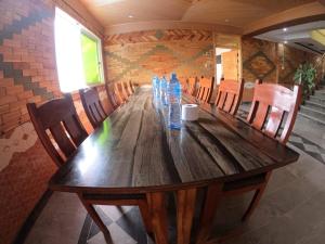 a long wooden table with bottles of water on it at Snow Land Hotel and Restaurant in Malam Jabba +15 photos