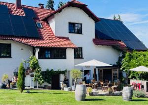 a house with solar panels on the roof at GENUSSZEIT Cottage in Udenhain