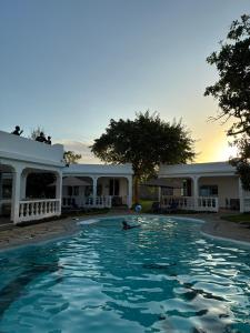 a person in the water in a swimming pool at M&H Boutique Hotel in Mombasa +17 photos