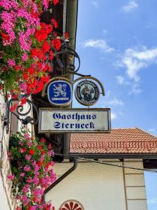 a sign on the side of a building with flowers at Gasthaus Stoiber in Buchbach