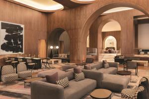 a lobby with couches and tables and a bar at Signia by Hilton San Jose in San Jose