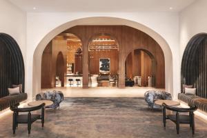 a lobby with chairs and tables in a building at Signia by Hilton San Jose in San Jose +131 photos