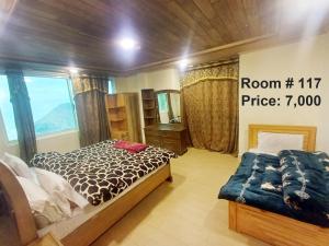 a room with a bed and a mirror in it at Snow Land Hotel and Restaurant in Malam Jabba