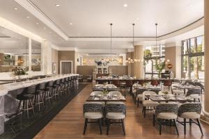 a restaurant with tables and chairs and a bar at Signia by Hilton San Jose in San Jose