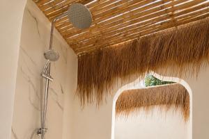 a bathroom with a shower with a straw ceiling at Glory Moon Resort in Bophut +79 photos