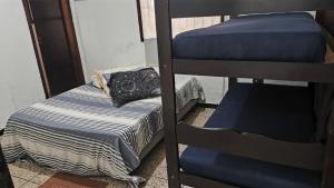 a room with two bunk beds and a purse at Pousada Pontal de Santa Marina - Caraguatatuba in Caraguatatuba +24 photos