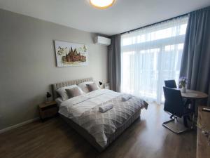a bedroom with a bed and a large window at DN Fly & Stay in Wrocław