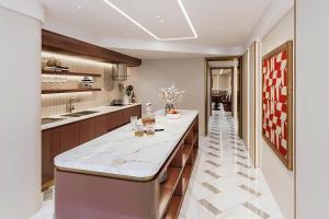 a kitchen with a counter with wine glasses on it at Ben Thanh Luxury Hotel - Premium Kas Dilly & Spa in Ho Chi Minh City