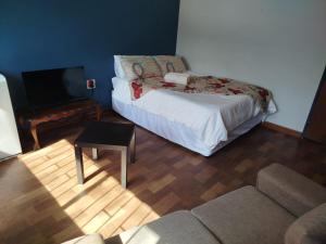a living room with a bed and a couch at Manor Rentals in Potchefstroom
