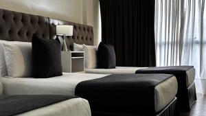 a hotel room with two beds and a large window at Ker Recoleta Hotel in Buenos Aires +31 photos