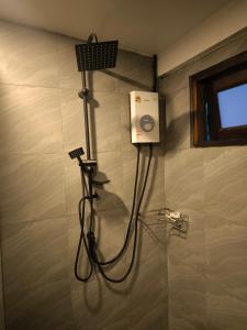 a shower in a bathroom with a hair dryer at Bakesense home 01 in Ko Phangan