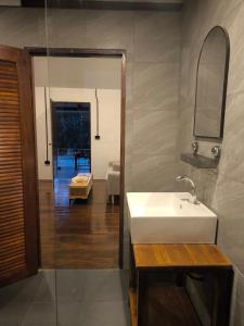 a bathroom with a white sink and a mirror at Bakesense home 01 in Ko Phangan