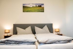 a bedroom with two beds with pillows on it at Gasthaus Stoiber in Buchbach