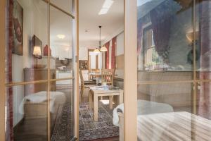 a room with a glass door leading to a bedroom at Hotel Garni Larcherhof in Mayrhofen +86 photos
