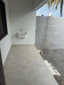 a bathroom with a sink and a concrete wall at Residential Florence Nightingale in Sorriso