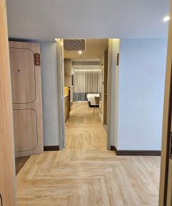 a hallway of an apartment with wooden floors at The Quarter Ladprao by UHG in Bangkok