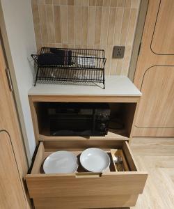 a cabinet with two white plates in it at The Quarter Ladprao by UHG in Bangkok