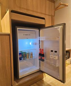 an open refrigerator filled with drinks and water bottles at The Quarter Ladprao by UHG in Bangkok +117 photos