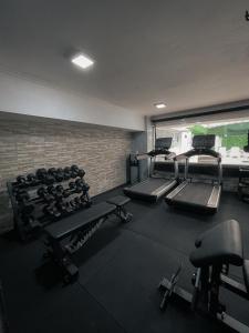 a gym with several treadmills and machines in it at Ker Recoleta Hotel in Buenos Aires
