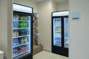 a refrigerator filled with lots of drinks in a store at Holiday Inn Express Toronto Downtown by IHG in Toronto +74 photos