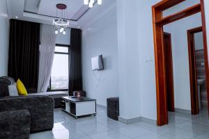 a living room with a couch and a table at Martin Aviator Apartment in Kigali +8 photos