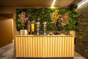 a counter with vases and flowers on top of it at King Gorgasali in Tbilisi City