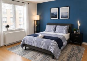 a bedroom with a bed with a teddy bear on it at Studio apart Time Square in New York