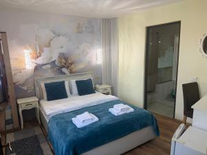a bedroom with a bed with towels on it at Casa Aurelia in Sibiu