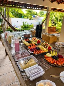 a buffet with fruits and vegetables on a table at Pousada Alter Villa Suítes in Alter do Chao