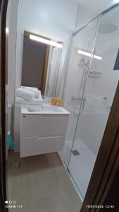 a bathroom with a white sink and a shower at Brisa Mar in Gran Tarajal +11 photos