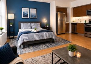 a large bedroom with a bed and a kitchen at Studio apart Time Square in New York