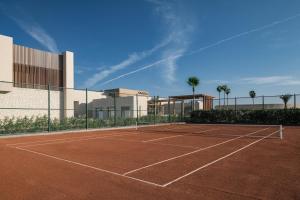 a tennis court in front of a building at JAZ Elite Riviera in Port Ghalib