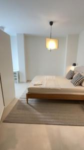 a bedroom with a bed and a light on the ceiling at Cosy place in Pembroke in Pembroke