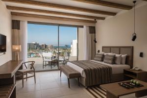 a bedroom with a bed and a balcony with a view at JAZ Elite Riviera in Port Ghalib
